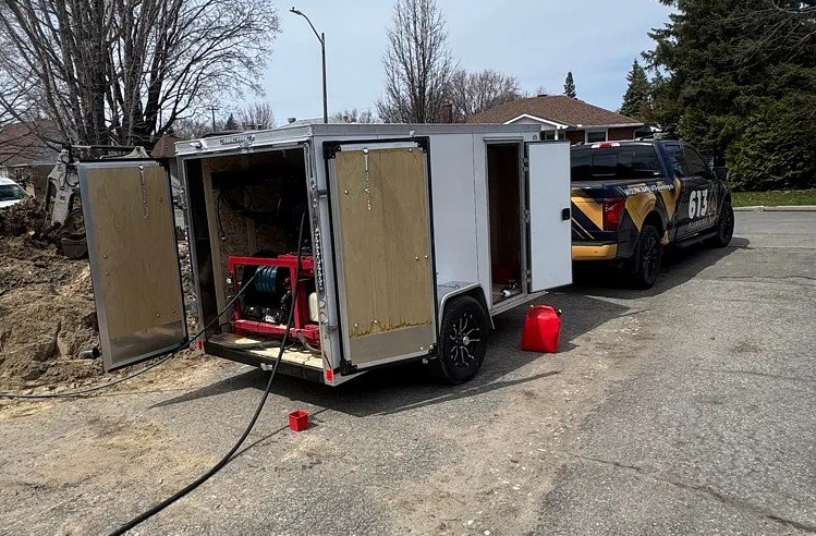 613 Plumbing equipment trailer and truck set up at a residential job site