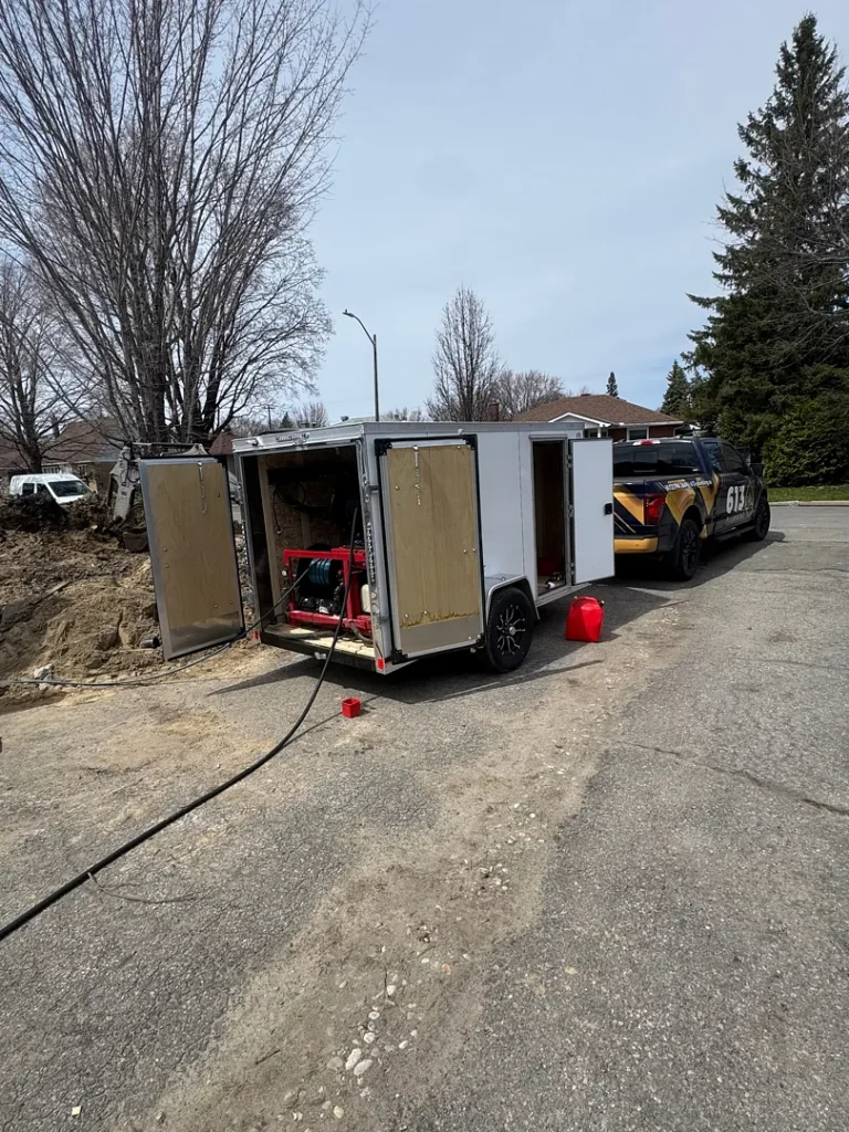 613 Plumbing equipment trailer and truck set up at a residential job site